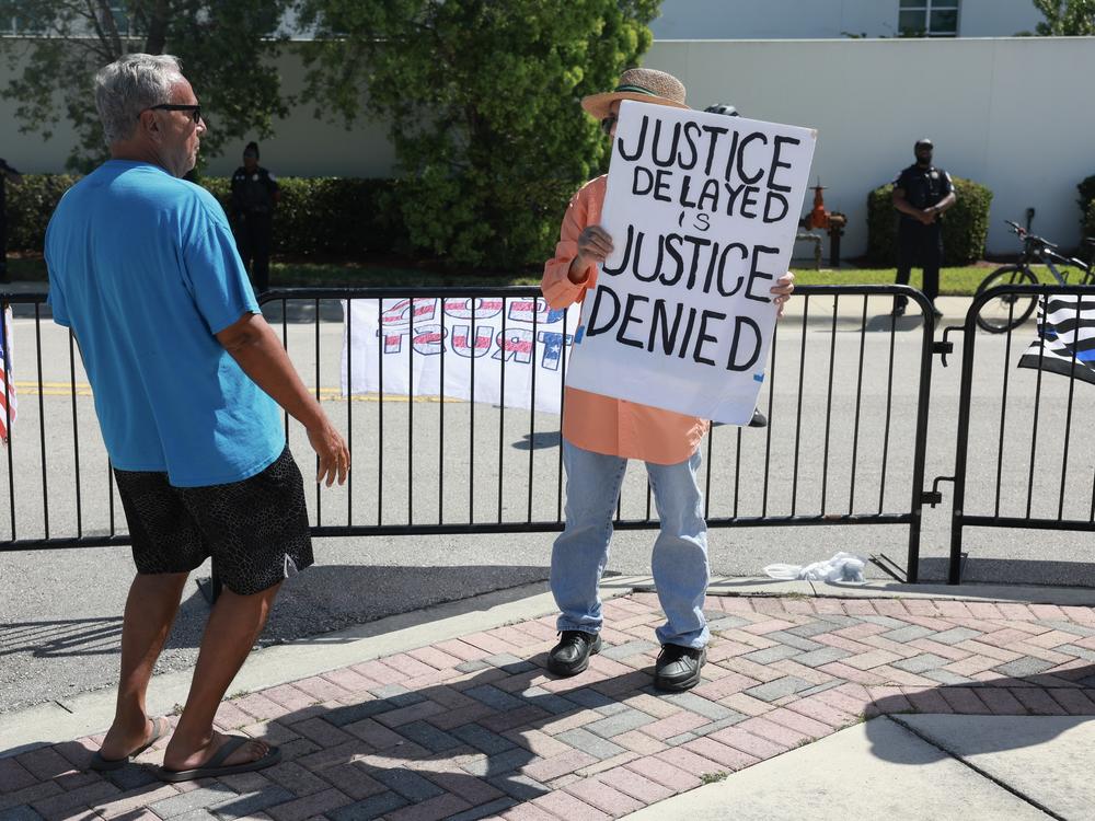 Supporters and non-supporters of former U.S. President Donald Trump stand outside the Alto Lee Adams Sr. U.S. Courthouse on March 14 in Fort Pierce, Fla. Trump visited the courthouse for his case in front of District Judge Aileen Cannon.