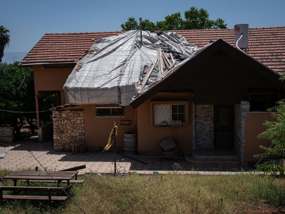 A tarp covers a hole resulting from Hezbollah rocket damage in the Israeli town of Kiryat Shmona, June 10.