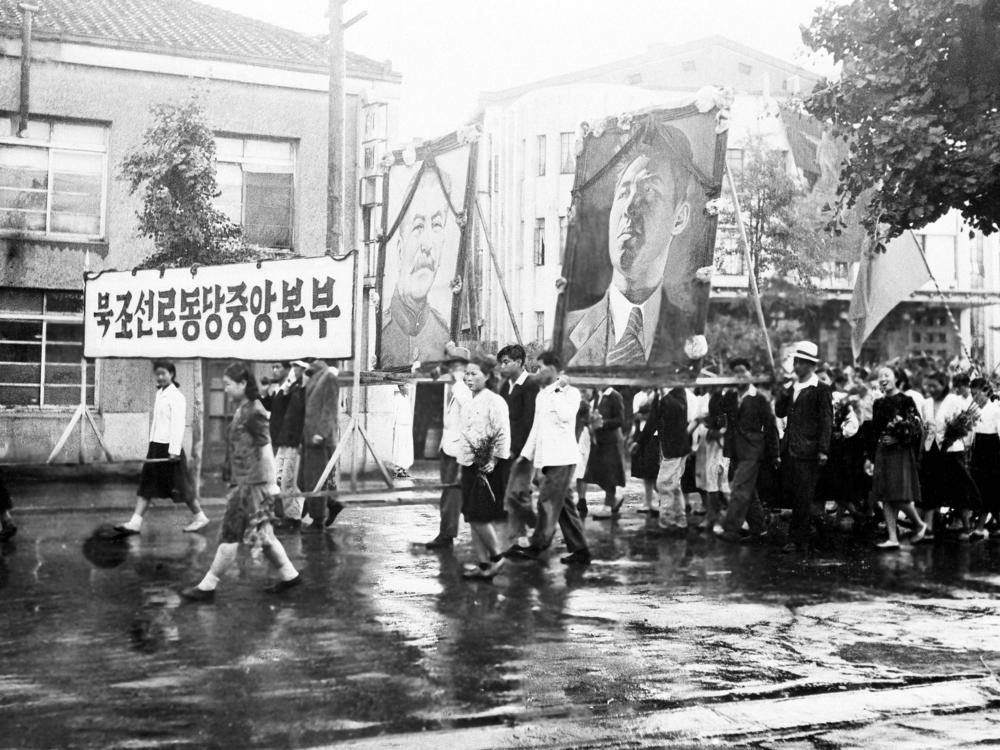 Part of a welcome for the United States-Soviet commission on Korea on their arrival in Pyongyang on July 23, 1947, was this parade of Korean communists carrying huge portraits of Josef Stalin and Kim Il Sung. The commission visited Pyongyang, 165 miles north of Seoul, for the purpose of getting views of political groups on the prospecting.