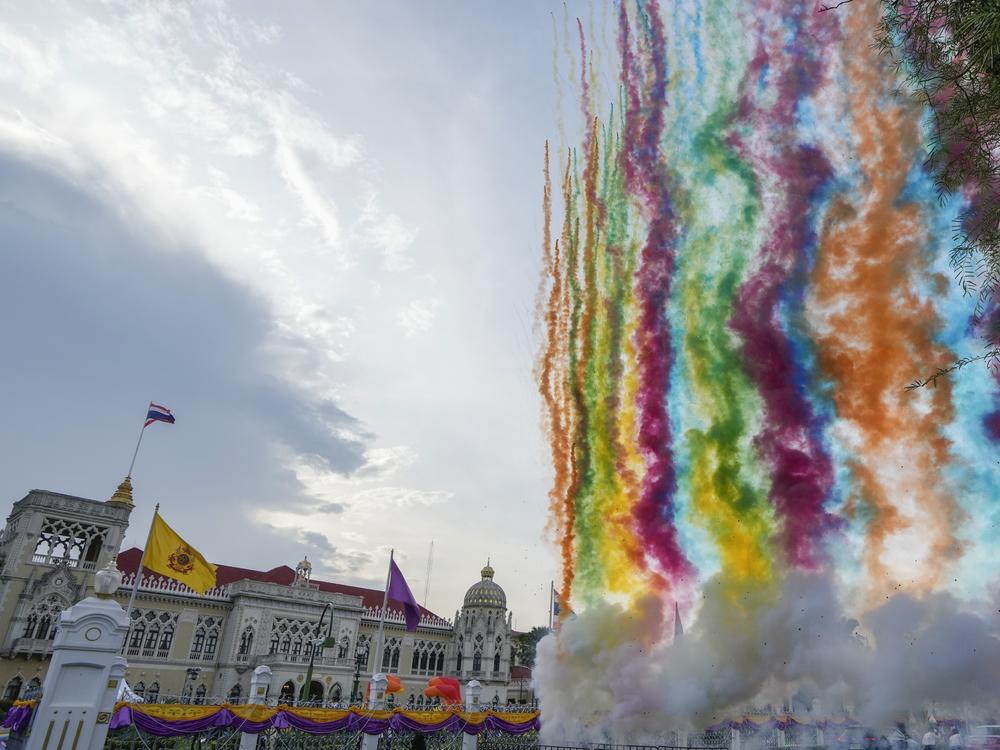Fireworks shoot up in to sky at government house in Bangkok, Thailand, Tuesday, on the day the Senate approved a bill that would legalize same-sex marriage.