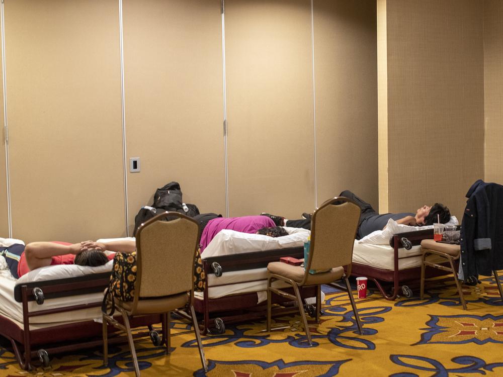 Residents of the Mescalero Apache Reservation rest while sheltering at the Inn of the Mountain Gods Resort in Ruidoso, N.M., on Tuesday.
