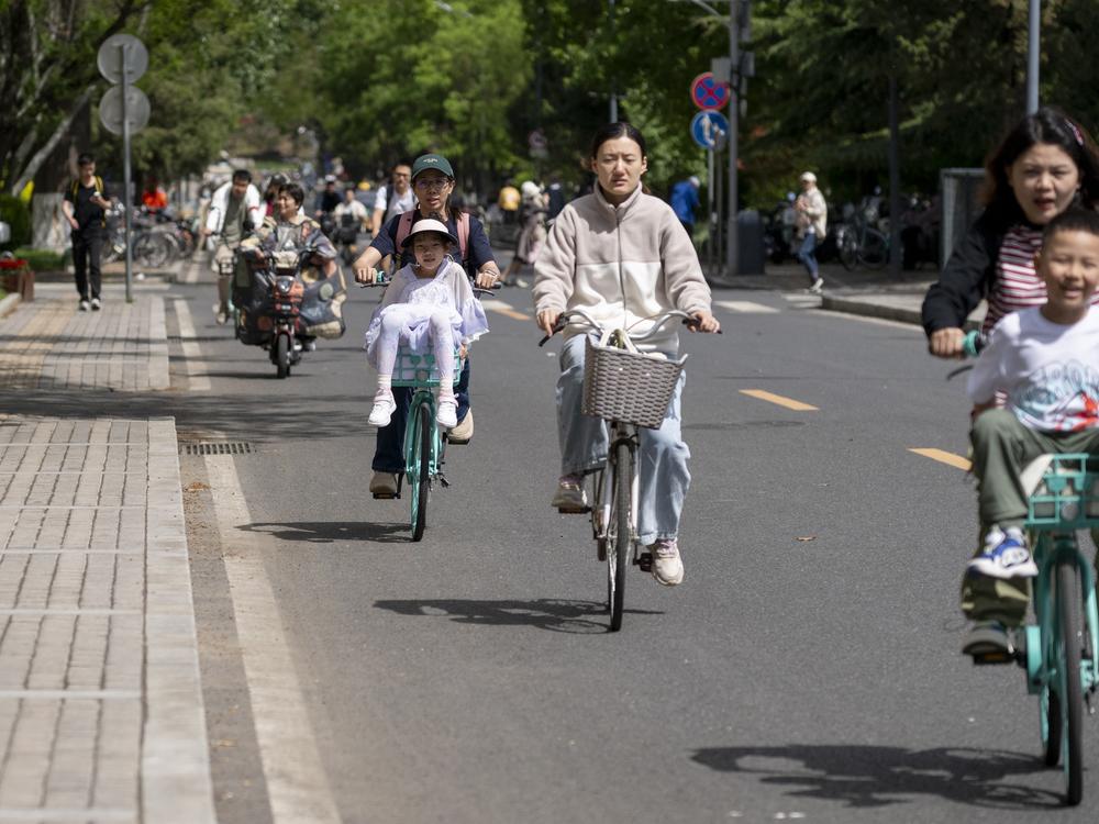 People cycling in Tsinghua University in Beijing, China on April 23, 2024. 