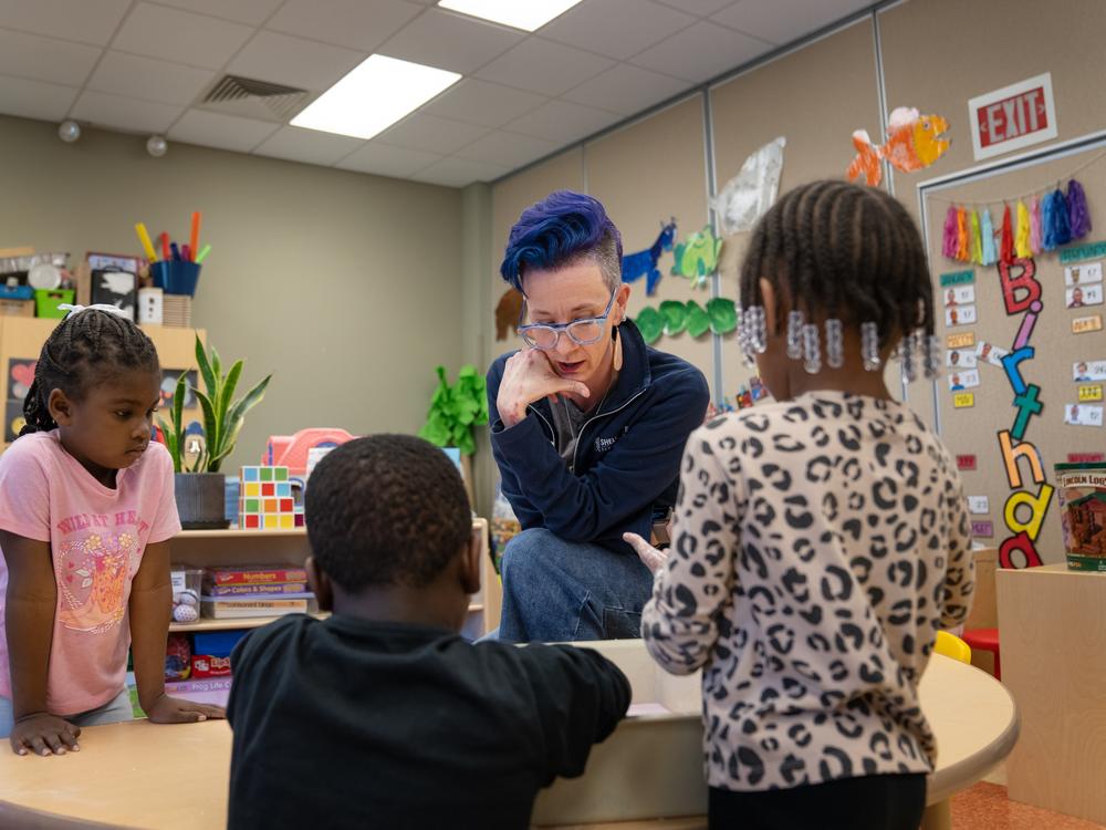 Holly Glasgow talks to children in the pre-K program she directs on the campus of Shelton State Community College in Tuscaloosa. Given the high cost of building child care centers like this one, Glasgow is focused on developing another model of child care — family child care homes.