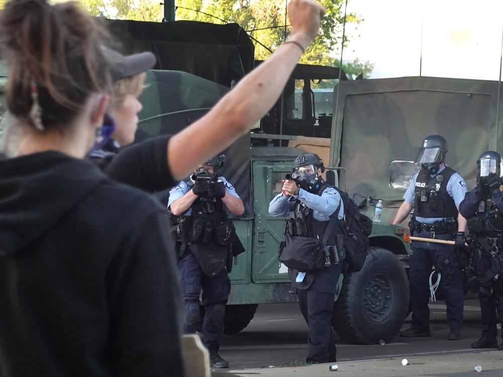 Police prepare to open fire with tear gas and nonlethal rounds on a group of demonstrators protesting the death of George Floyd on May 29, 2020, in Minneapolis, Minn.  
