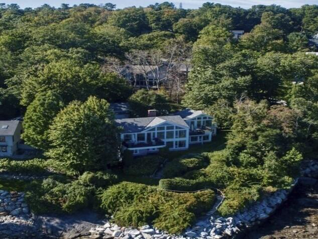 This image provided by Vinal Applebee shows the home of Lisa Gorman in the foreground, the poisoned oak trees behind her home, and the home of the alleged perpetrators behind the dead trees, in Camden, Maine.