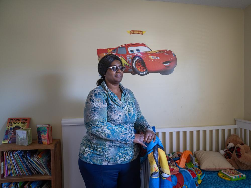 Lakethia Clark stands in her son's bedroom in her home in Tuscaloosa, Alabama. Clark will soon open her own home-based child care business.
