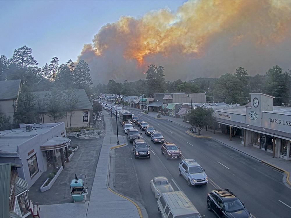 In this image taken from webcam footage provided by the Village of Ruidoso, smoke rises behind Ruidoso, N.M., on Monday.