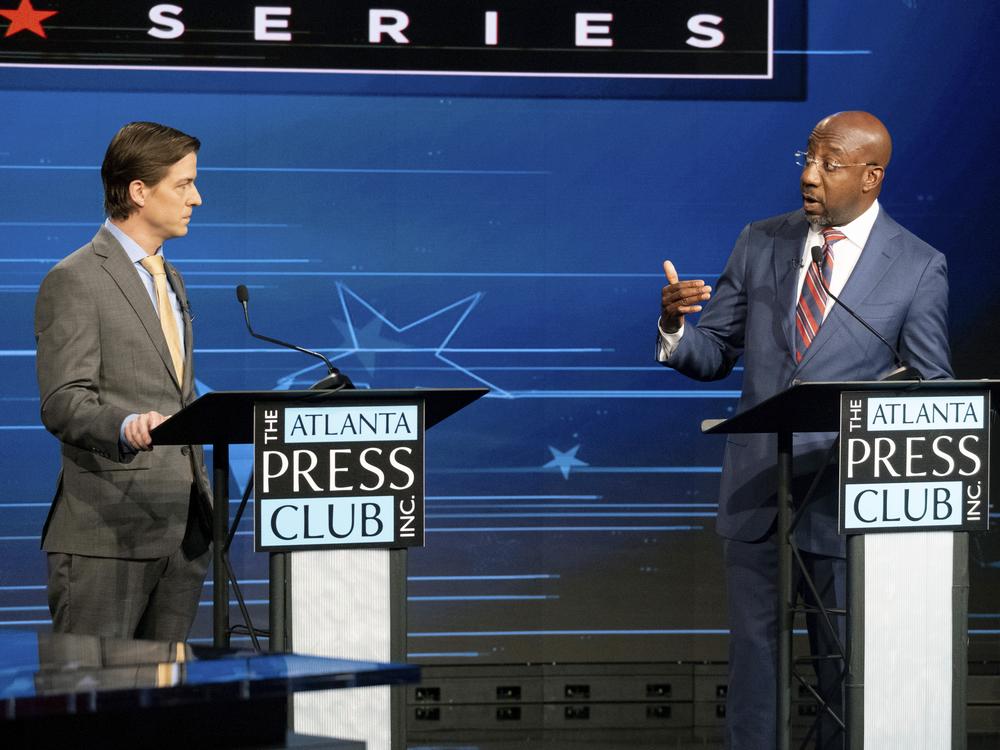 In this 2022 photo, Libertarian challenger Chase Oliver, left, and Sen. Raphael Warnock, D-Ga., participate in a U.S. Senate debate in Atlanta on Sunday, Oct. 16, 2022. Republican challenger Herschel Walker was invited but did not attend. Oliver's candidacy in the race is largely responsible for forcing the two leading candidates, Warnock and Walker, to a runoff. 