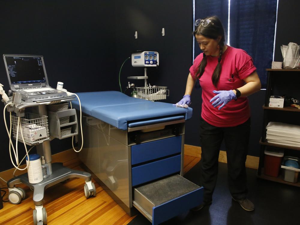 Staff member Katie Yates preps the procedure room in Richmond. There’s one blue cushioned exam table where Dr. Arnold performs abortions, skin tag and mole removal, pelvic exams, biopsies and IUD placements.