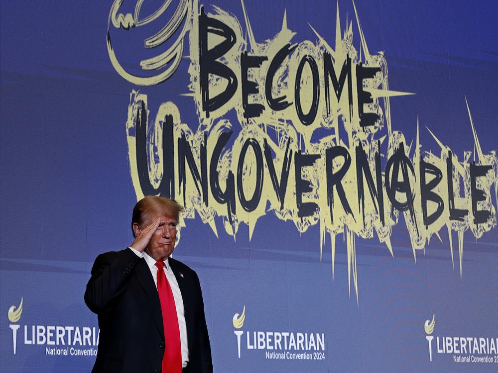 Former President and Republican presidential candidate Donald Trump salutes to the audience after addressing the Libertarian Party National Convention on May 25 in Washington, D.C.