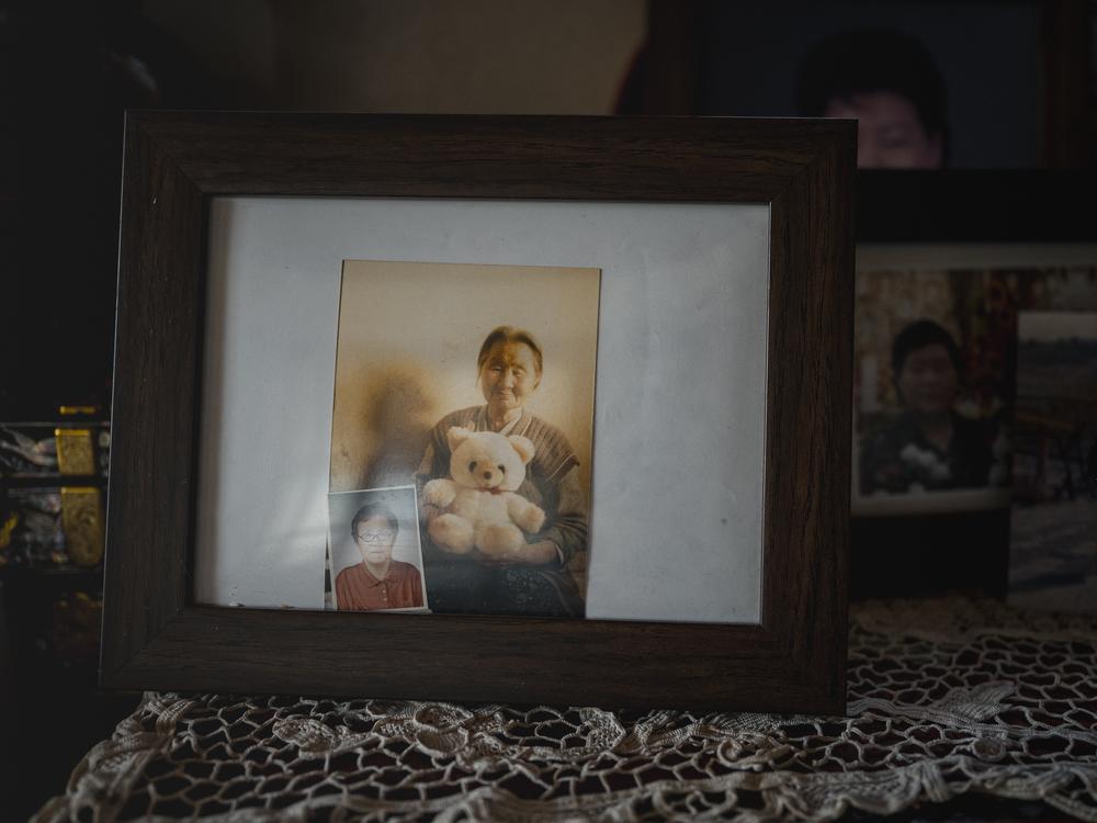 Old photos of Kim Yong-jae’s mother (left) and grandmother sit in a frame at Kim’s home in Sokcho, South Korea, on Sept. 12, 2023.