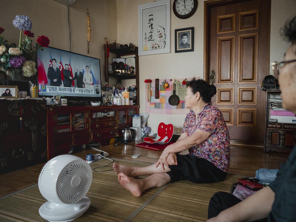 Kim Yong-jae, 82, left, and her friend, Kwon Gye-soon, 70, watch the news of a meeting between North Korean leader Kim Jong Un and Russian President Vladimir Putin in Kim’s home in Abai Village on Sept. 12, 2023.