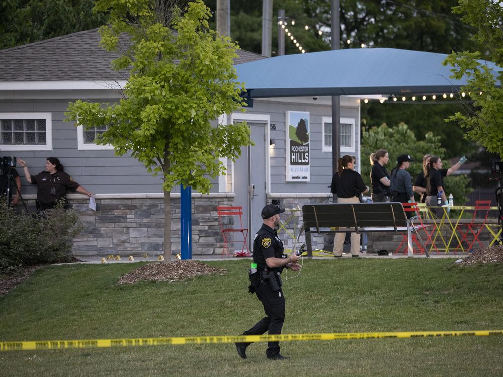 Police investigate the scene of a shooting on June 15 at the Brooklands Plaza Splash Pad in Rochester Hills, Michigan, where a gunman wounded nine people.