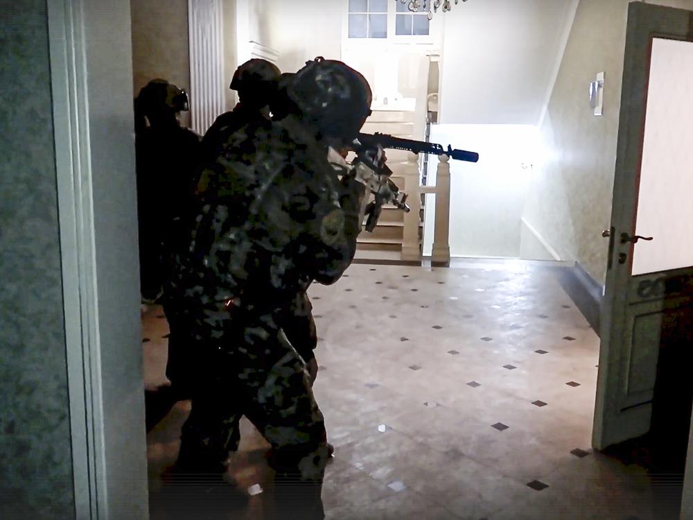 In this photo taken from video released by Russia's National Antiterrorism Committee on Monday, FSB officers conduct a counterterrorist operation in the Dagestan Republic. Gunmen killed multiple police officers and several civilians, including an Orthodox priest in the Russian republic on Sunday.