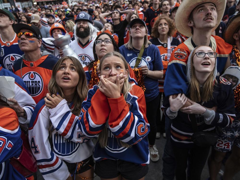 Edmonton Oilers fans react in Edmonton, Alberta, after the team's loss to the Florida Panthers in Game 7 of the NHL hockey Stanley Cup Final in Sunrise, Fla., on Monday. 