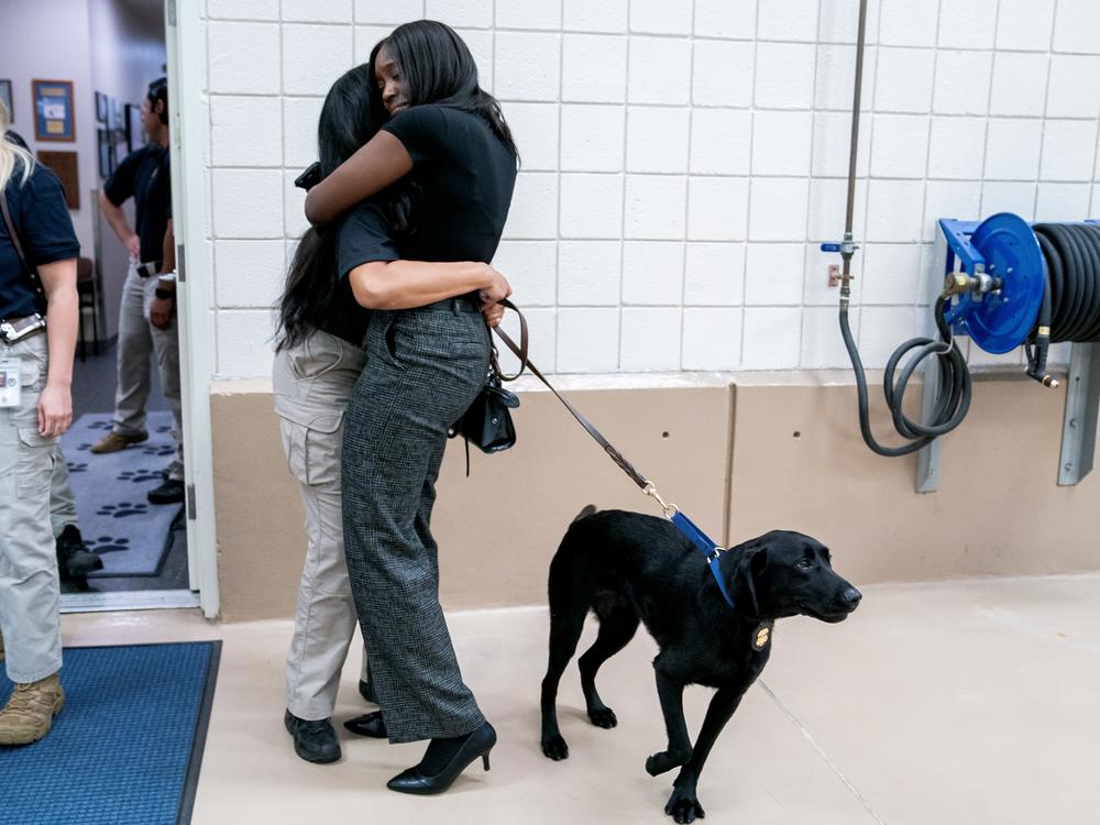 Special Agent Mariah Maye hugs her friend Jazmine Wright following a graduation ceremony for Bureau of Alcohol, Tobacco, Firearms and Explosives (ATF) special agent canine handlers and their dogs at the ATF training facility in Front Royal, Va., on Friday, June 21, 2024.