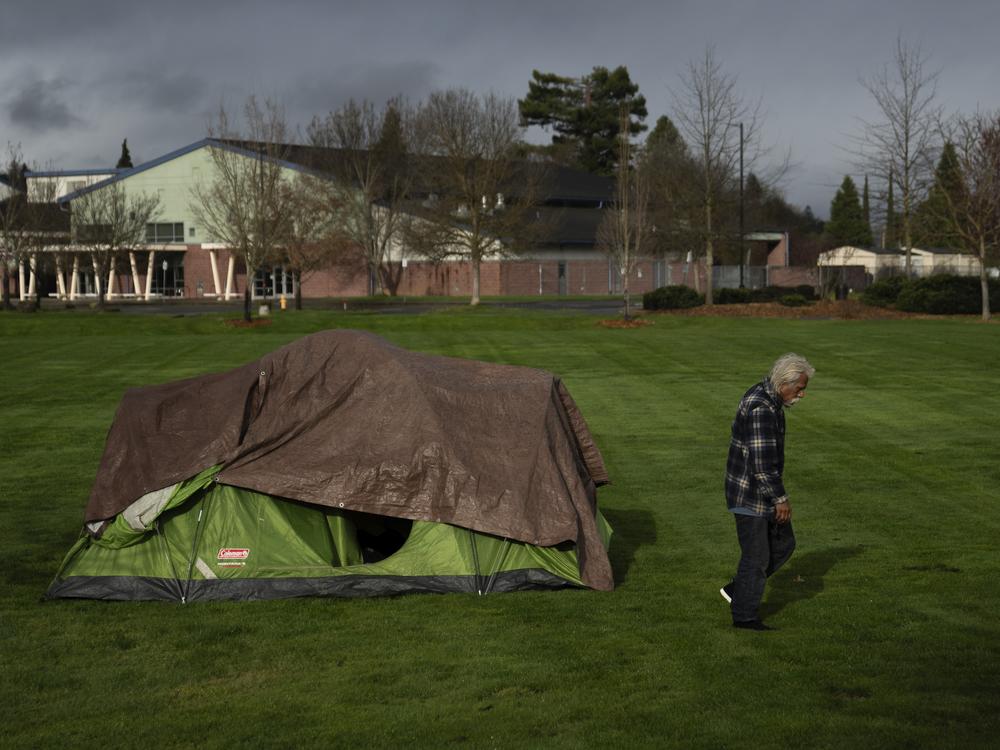 A homeless person walks near an elementary school in Grants Pass, Ore., on March 23.  The rural city became the unlikely face of the nation's homelessness crisis when it asked the U.S. Supreme Court to uphold its anti-camping laws. 