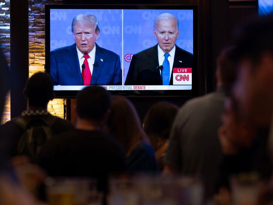 Guests at the Old Town Pour House watch a debate between President Biden and former President Donald Trump on Thursday in Chicago. The debate is the first of two scheduled between the two candidates before the November election.