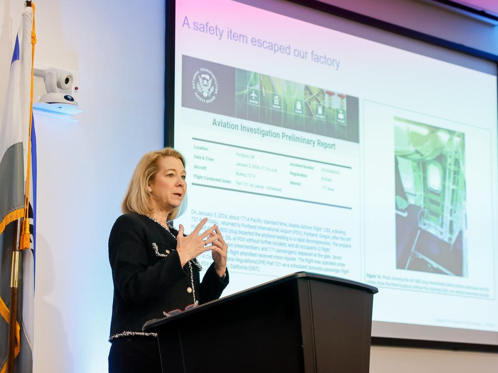 Elizabeth Lund, senior vice president of quality at Boeing, speaks to gathered media on Tuesday in front of a slide detailing the door plug blow-out that occurred on Jan. 5, 2024, on Alaska Airlines Flight 1282.