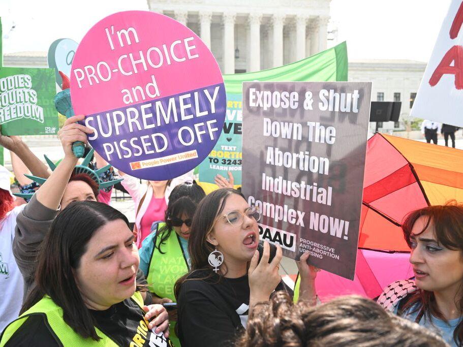 Protesters rally outside the U.S. Supreme Court on April 24 as it hears arguments on whether an Idaho abortion law conflicts with the federal Emergency Medical Treatment and Labor Act.