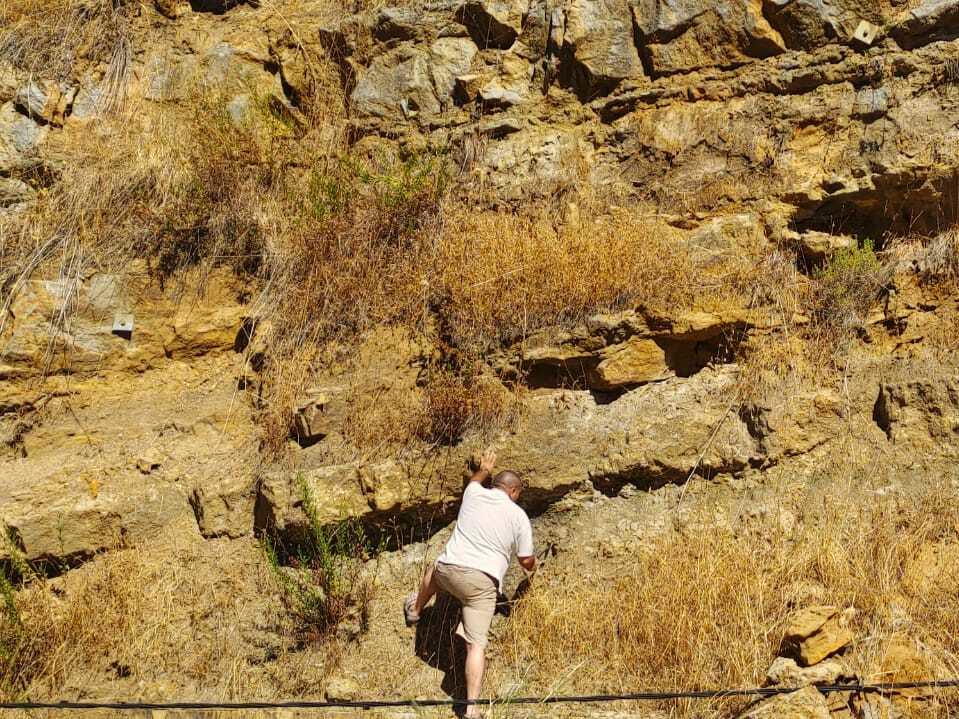  Azar searches for amber along a rocky face in the area of Hadath el Joubbeh in 2023. 