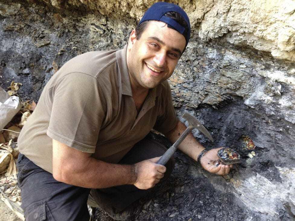  Danny Azar holds a large amber specimen, found in the area of Wadi Jezzine in 2015. 