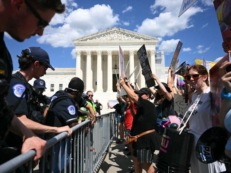 U.S. Supreme Court Police officers put up barricades to separate anti-abortion activists from abortion rights activists during a demonstration in front of the Supreme Court in Washington, DC, on June 24, 2024. 