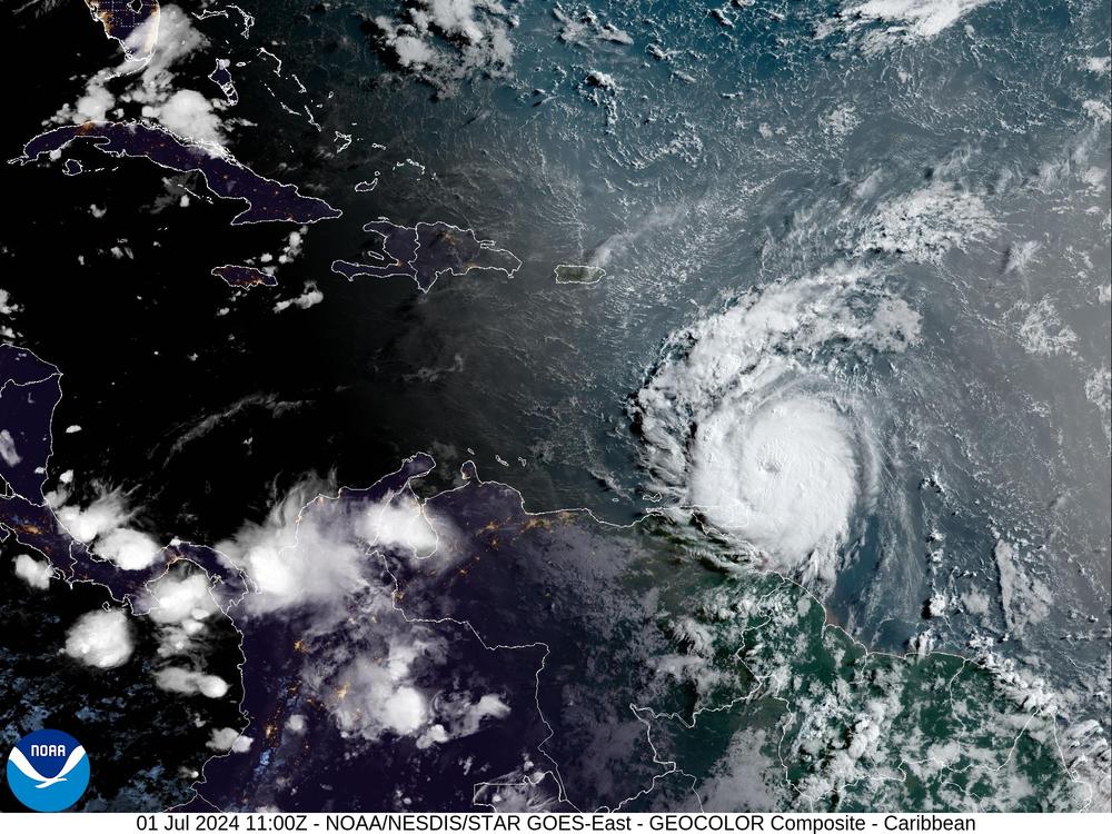 Hurricane Beryl loomed toward St. Vincent — and grew in power — as it brought threats of catastrophic winds and dangerous storm surges to the Windward Islands. The storm is seen here in a satellite image just after sunrise on Monday.