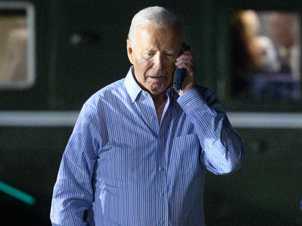 President Biden speaks on the phone while walking to board Air Force One after a fundraiser in New Jersey on Saturday.