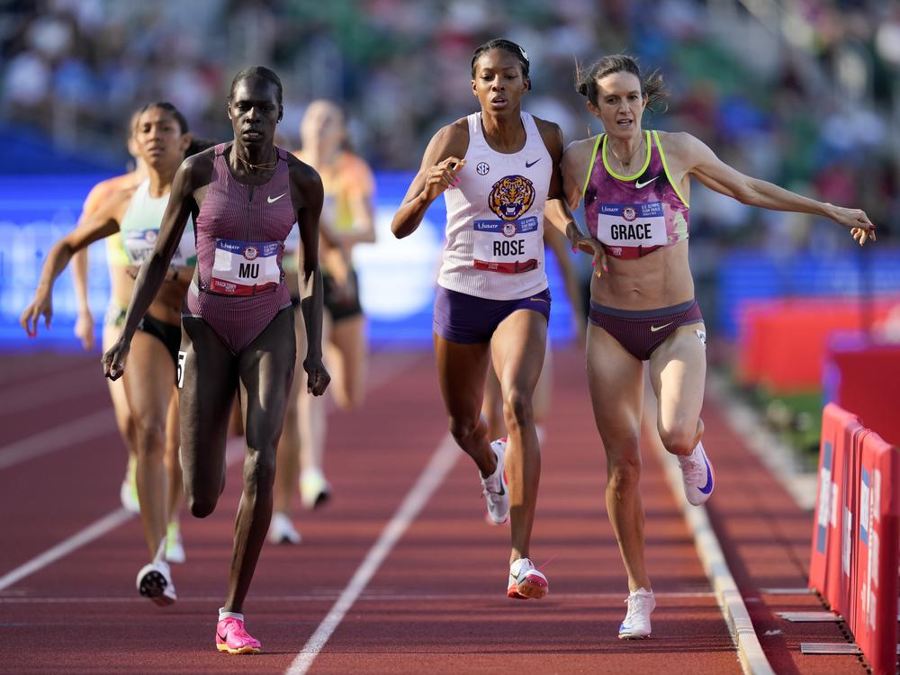 Athing Mu wins a heat in the women's 800-meter semi-final as Kate Grace and Michaela Rose collide during the U.S. Track and Field Olympic Team Trials on Sunday in Eugene, Ore.