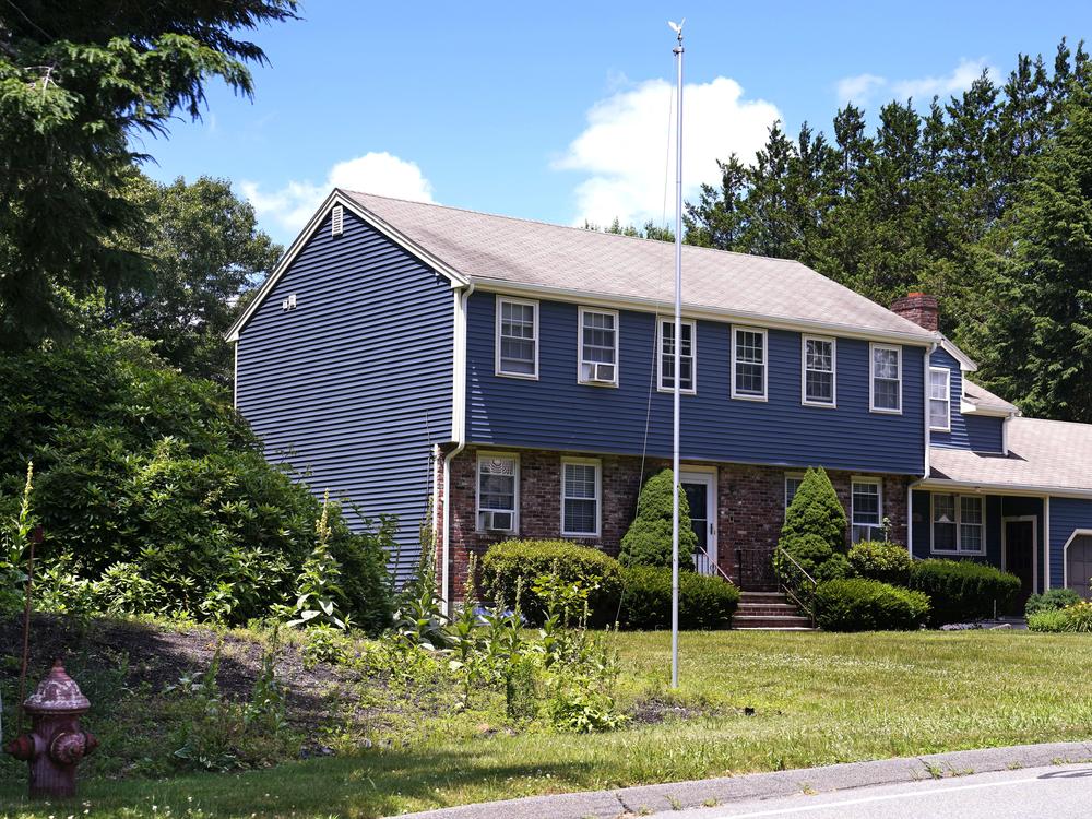 An empty flagpole is seen outside the Canton, Mass., residence where O'Keefe's body was found in the snow on Jan. 29, 2022.