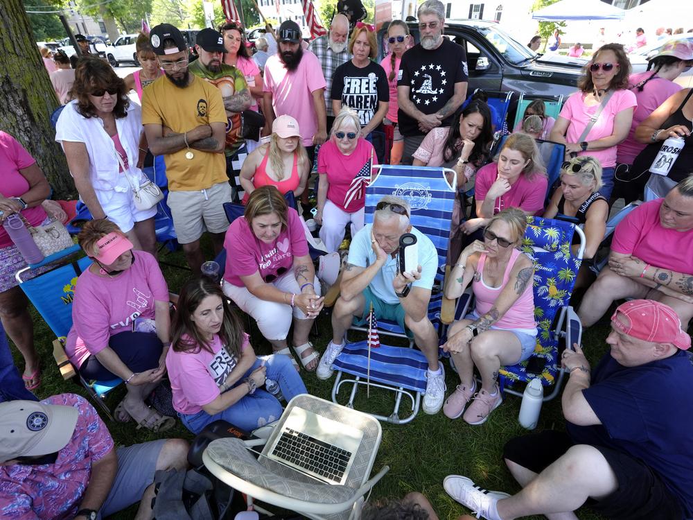 Supporters of Karen Read listen to proceedings from Read's trial from a laptop computer while gathered a block away from Norfolk Superior Court on June 25.