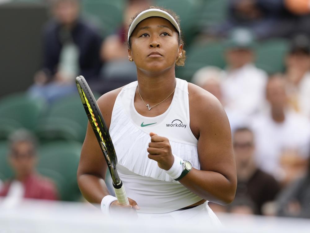 Naomi Osaka of Japan reacts after winning a point against Diane Parry of France during their first round match of the Wimbledon tennis championships in London, Monday, July 1, 2024. (AP Photo/Kirsty Wigglesworth)