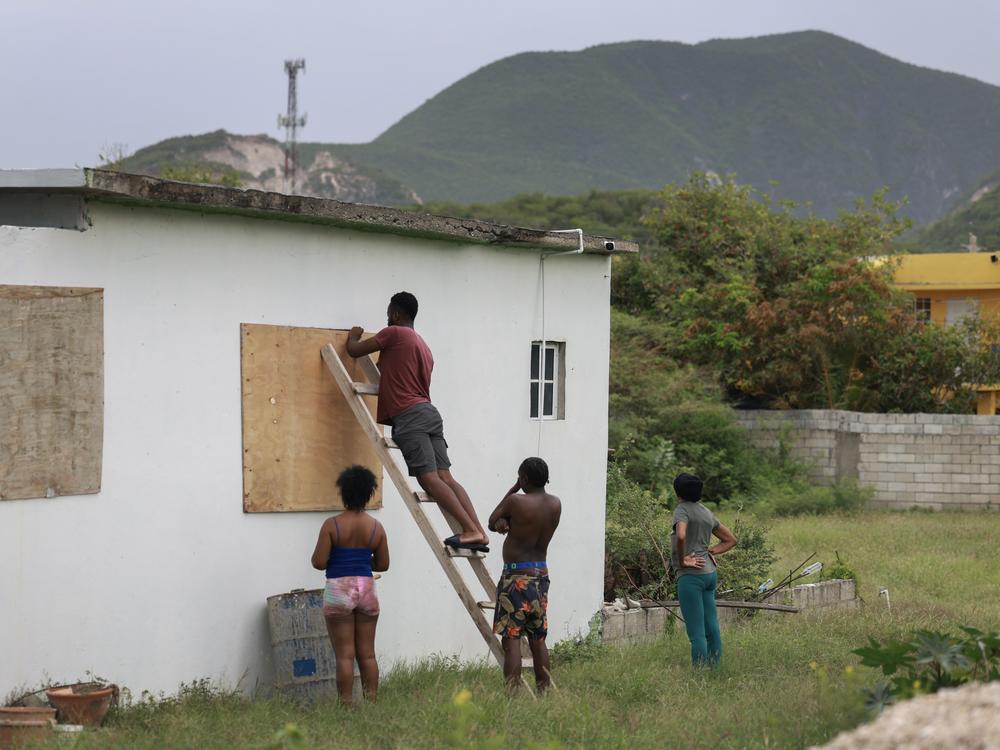 People place plywood over windows as they make last-minute preparations for the arrival of Hurricane Beryl in Kingston, Jamaica, on Wednesday.