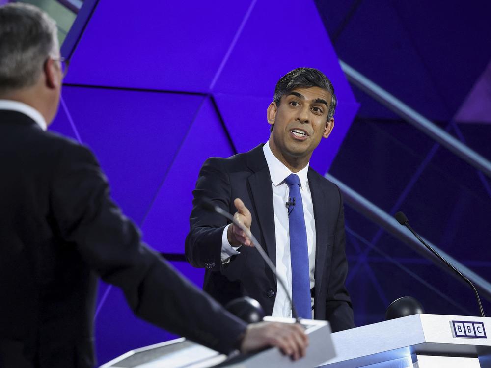 British Prime Minister Rishi Sunak and opposition Labour Party leader Keir Starmer (with back to camera) take part in the BBC's prime ministerial debate, in Nottingham, England, on June 26.