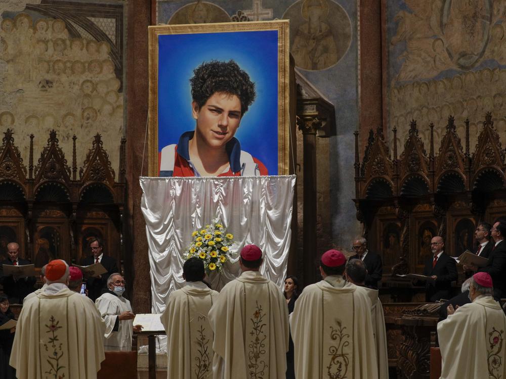 An image of 15-year-old Carlo Acutis is unveiled during his beatification ceremony at the St. Francis Basilica in Assisi, Italy, in October 2020.  