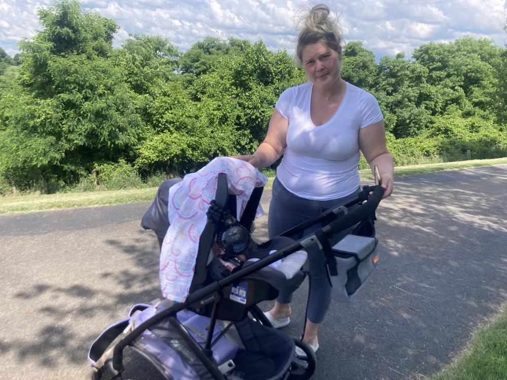 Molly Loveland and her daughter, Maya, at a park in Washington, Pennsylvania. Loveland works at a nearby nursing home. Loveland is concerned about catching COVID and bringing it home to her baby after her return to work. Federal data show that just 4 out of 10 nursing home residents in the U.S. have gotten at least one dose of the most recent COVID vaccine, which was released last fall.