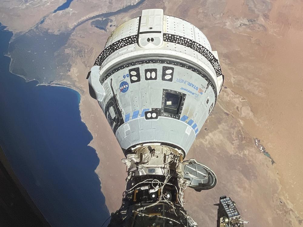 The Starliner spacecraft docked with the International Space Station and orbiting 262 miles above Egypt's Mediterranean coast on June 13. NASA says additional testing is needed before Starliner can return to Earth.