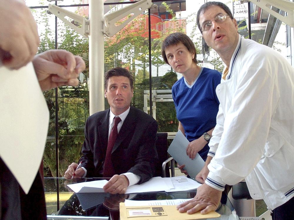 British environmental activists Helen Steel (second right) and David Morris (right) discuss with their lawyer, Keir Starmer (seated), as they wait for the beginning of their hearing at the European Court for Human Rights on Sept. 7, 2004, in Strasbourg, eastern France.