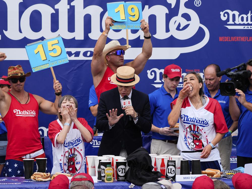 Miki Sudo (right) and Mayoi Ebihara compete in the women's division of Nathan's Famous Fourth of July hot dog eating contest, Thursday, at Coney Island in the Brooklyn borough of New York. Sudo won by eating a record 51 hot dogs.