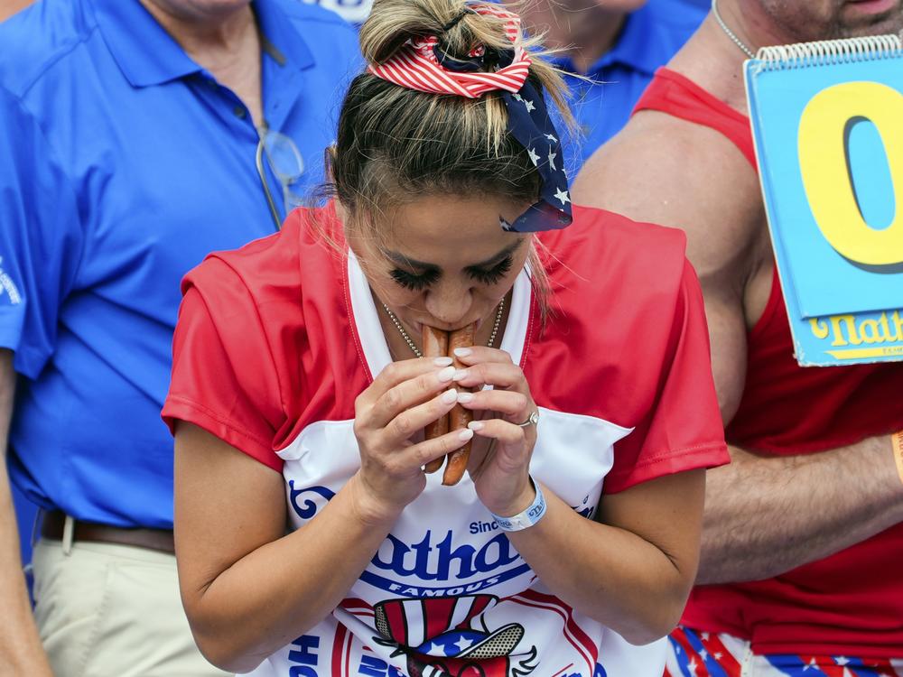 Miki Sudo competes in the Nathan's Famous Fourth of July hot dog eating contest, Thursday, at Coney Island in the Brooklyn borough of New York. Sudo ate a record 51 hot dogs.