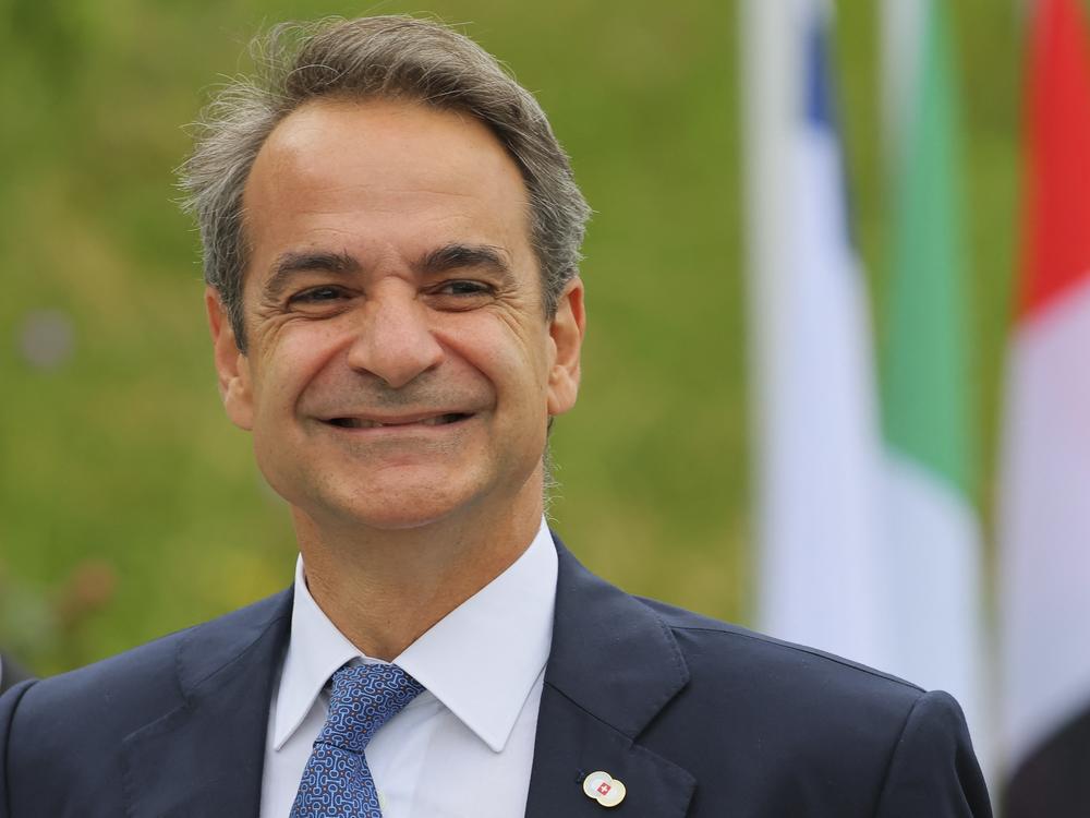 Greek Prime Minister Kyriakos Mitsotakis arrives to take part in a Ukraine peace summit near Lucerne, Switzerland, on June 15. Mitsotakis' administration says making six days of work mandatory is necessary due to a shrinking population and a shortage of skilled workers.
