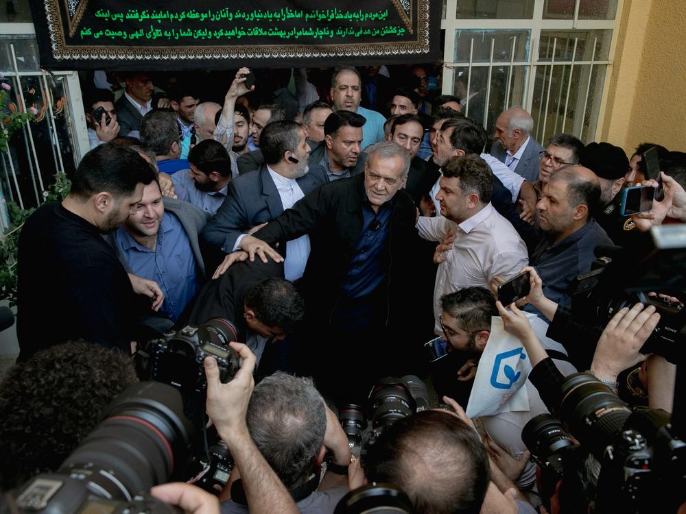 Masoud Pezeshkian, one of the two candidates qualifying for the second round of the Iranian presidential election, arrives at a polling station to cast his vote in Tehran on Friday.