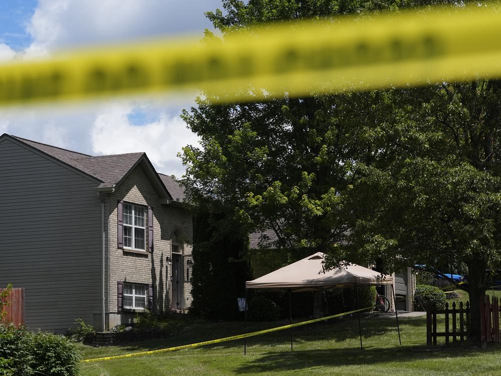 Yellow police tape is seen around the perimeter of a home where a shooting took place on Saturday in Florence, Ky. 