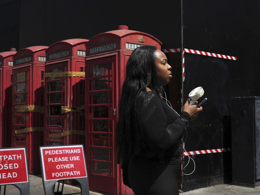 A woman cools herself with a fan during a hot day in London on June 26, 2024. June 2024 was the hottest June on record, according to Europe's Copernicus climate service.