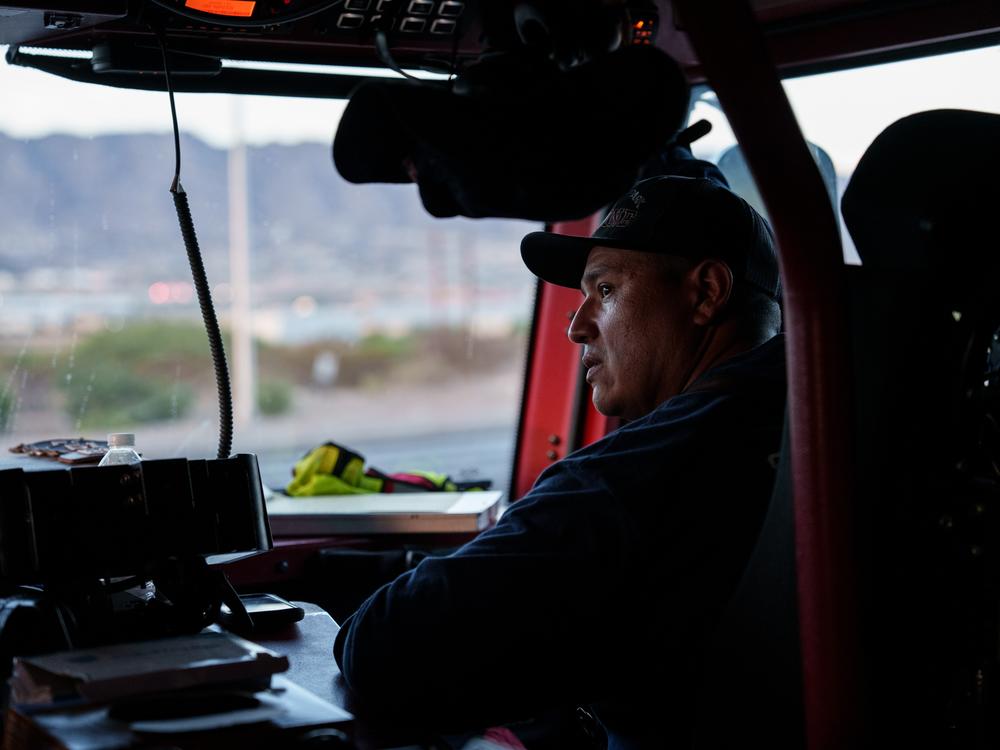 Sunland Park Fire Department Captain Abraham Garcia, 40, rides in the passenger side of a fire engine after the team responded to a call in Sunland Park, N.M., on Friday, June 28, 2024.