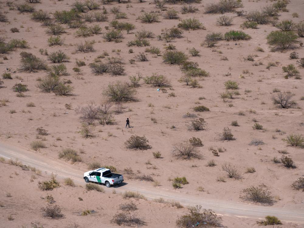 A man is chased by U.S. Border Patrol agents while running through the desert after crossing the U.S.-Mexico border in Sunland Park, N.M., on Friday, June 28, 2024. Sunland Park, which is situated right on the border, has seen an uptick in migrants attempting to cross into the U.S. undetected in recent years.  