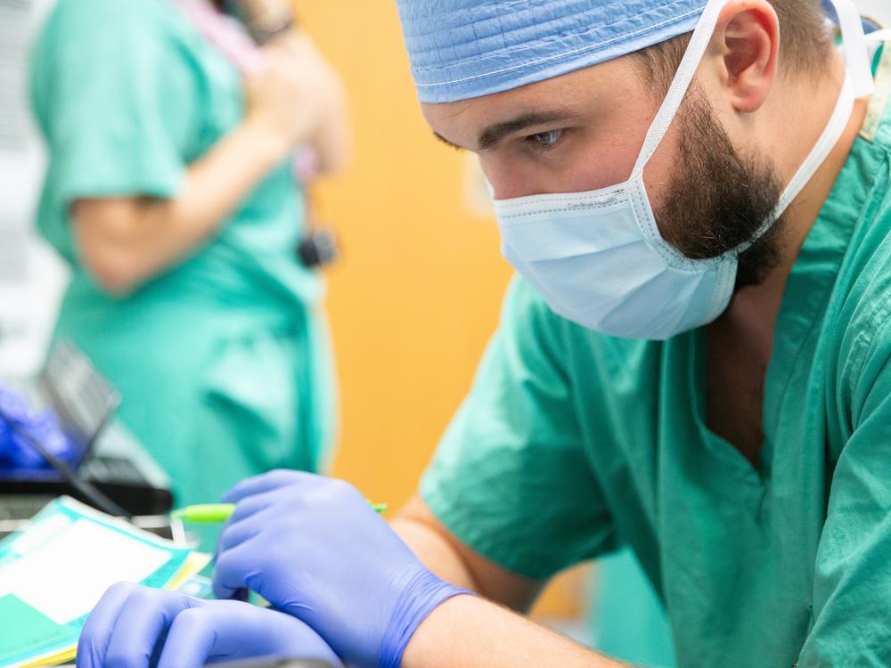Preston Lambert, a member of the Tennessee Donor Services team, monitors a donor's vital signs in preparation for a normothermic regional perfusion organ recovery.