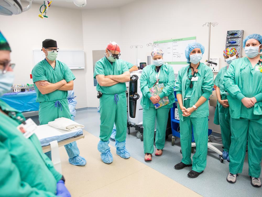 Dr. Marty Sellers, center, waits with an organ recovery team from Tennessee Donor Services before they being a procedure at a hospital in eastern Tennessee.