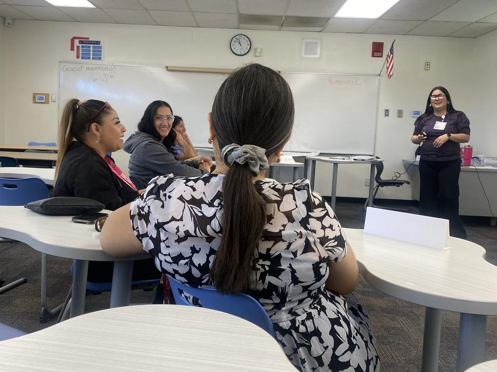 A half dozen women gather to discuss caregiving issues with their instructor Idely Valenzuela as part of the Kith and Kin program.